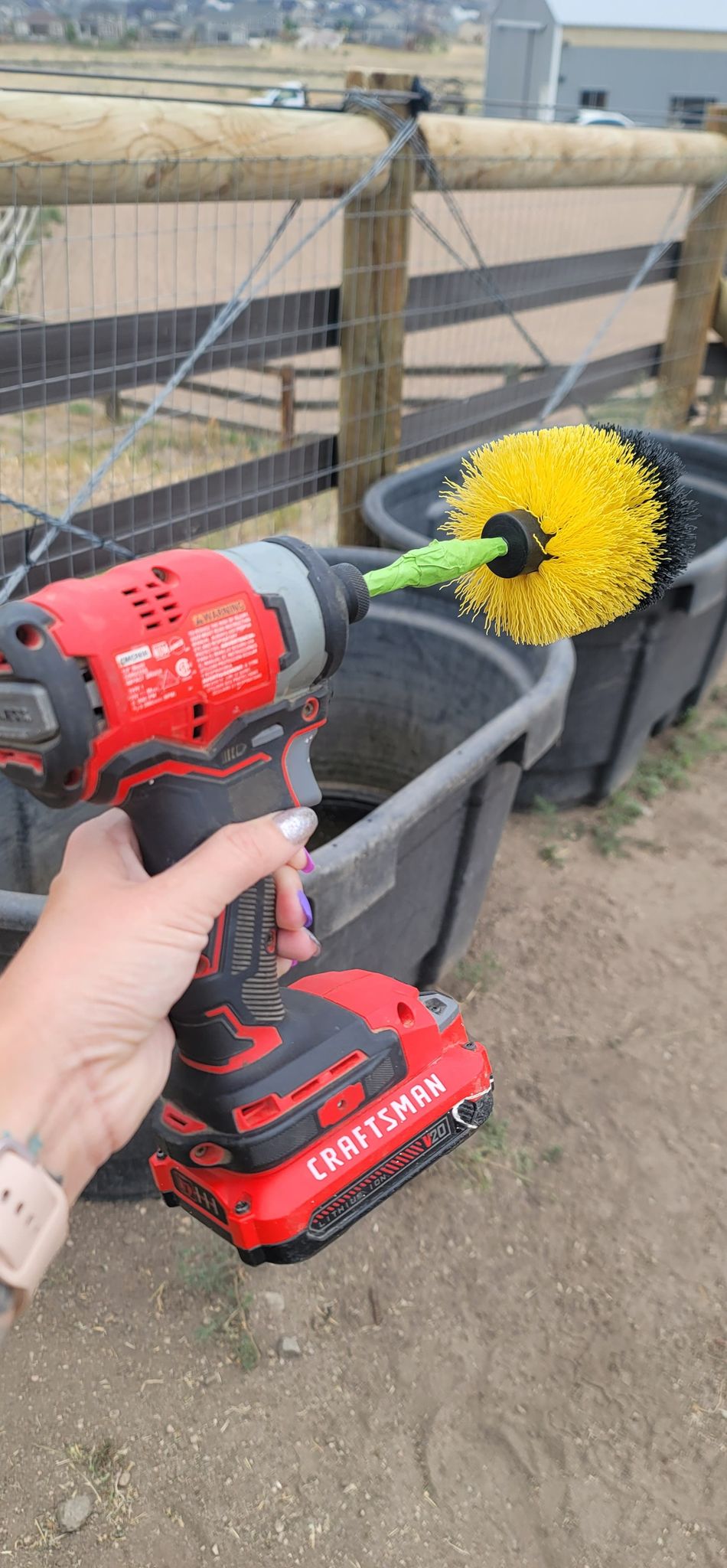 Cleaning a Water Trough with an Electric Drill